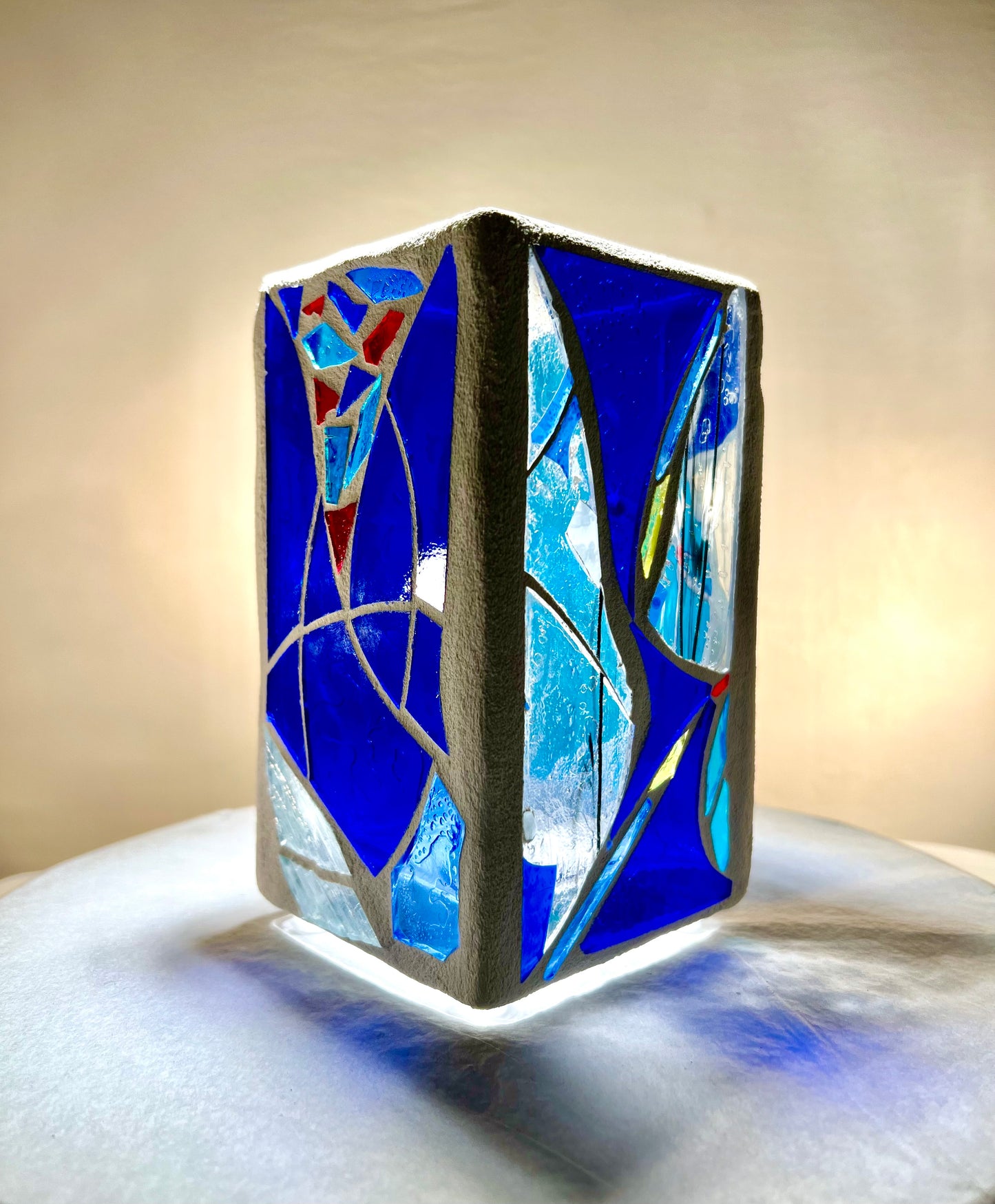 "Blue Vessel" Stained glass candleholder , blue, a little red, and crystal clear glass, bright white grout