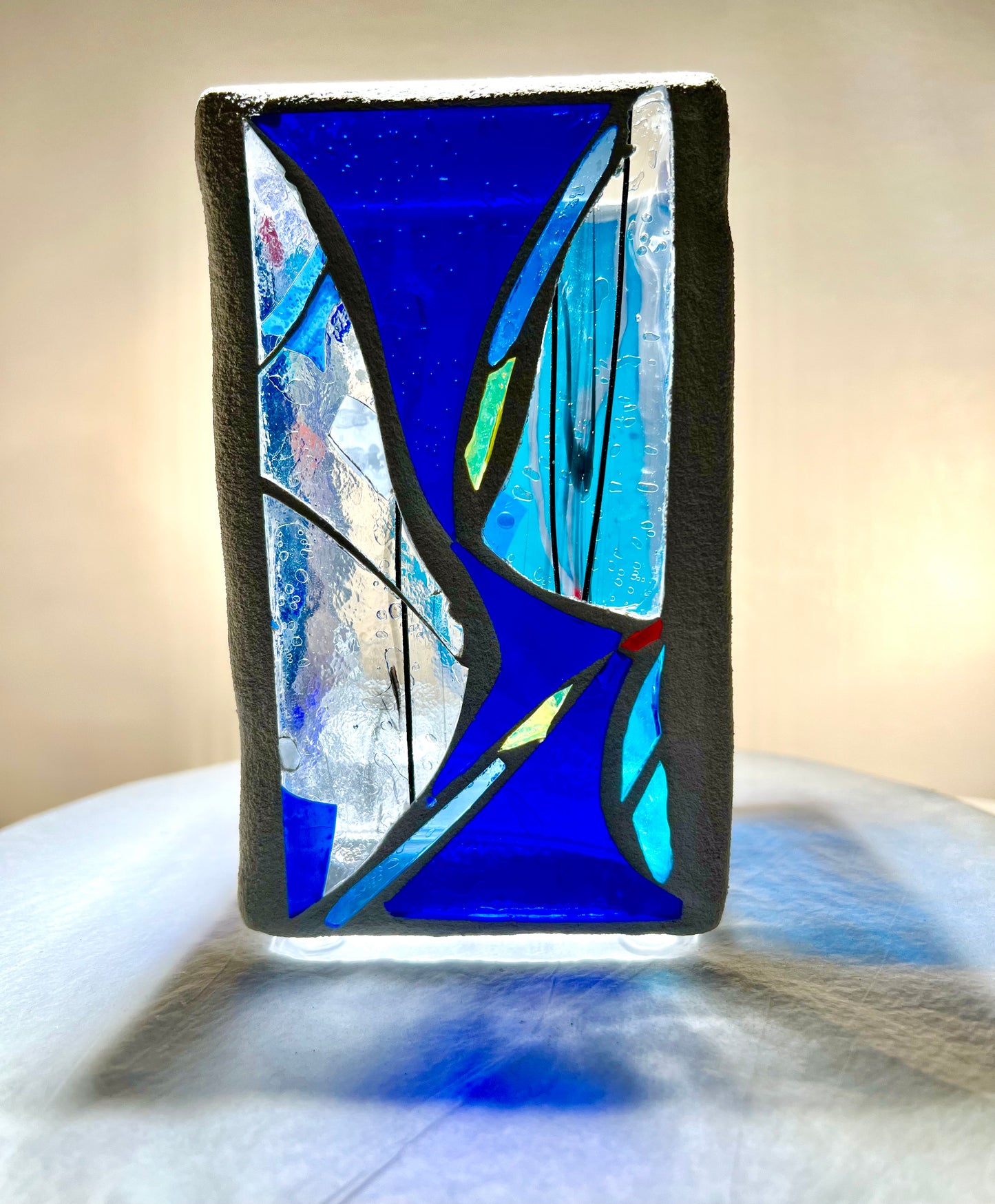 "Blue Vessel" Stained glass candleholder , blue, a little red, and crystal clear glass, bright white grout