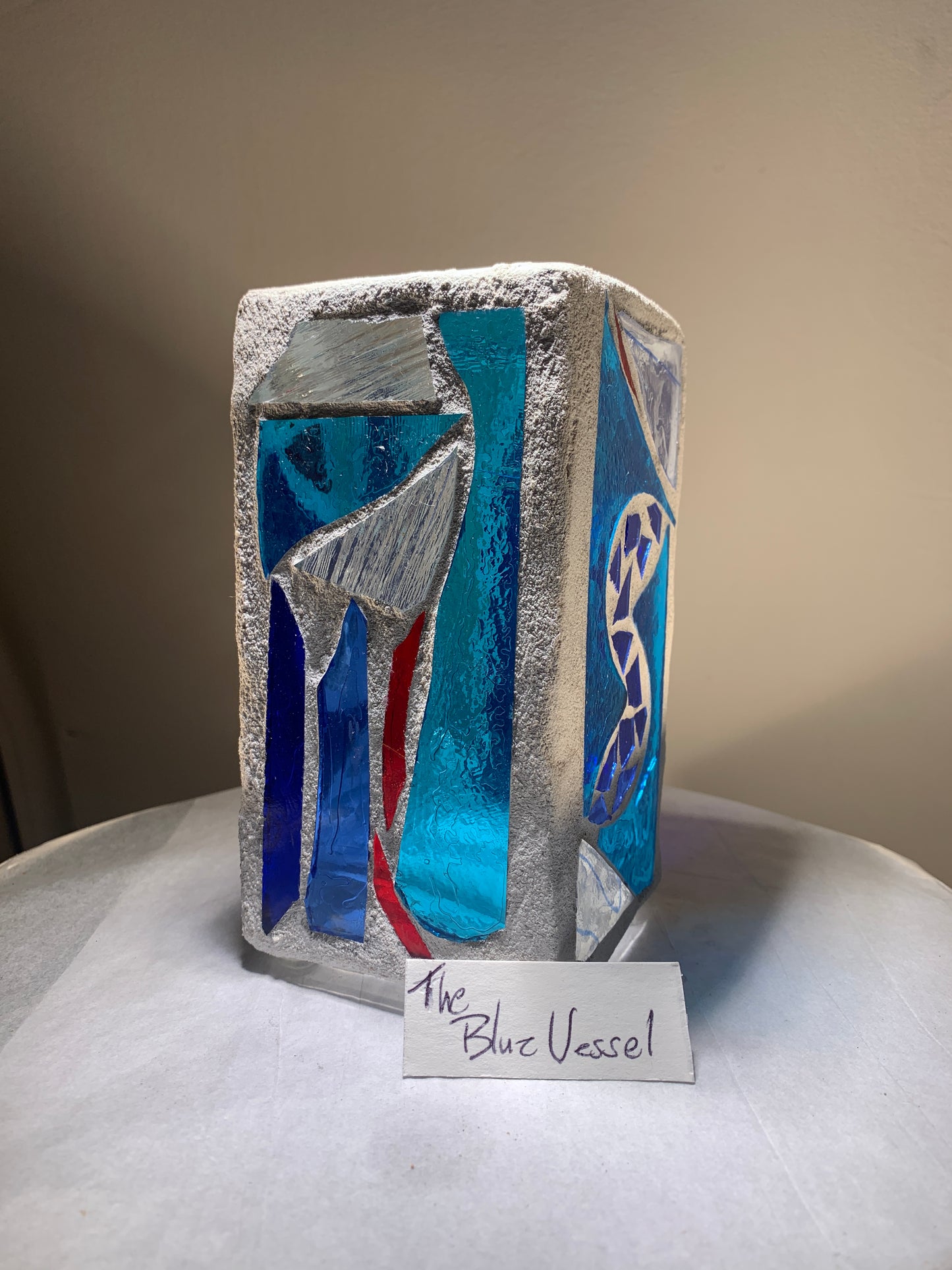 "Blue Vessel" Stained glass candleholder , blue, a little red, and crystal clear glass, bright white grout